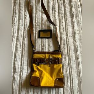 Yellow and tan side body purse. Has adjustable straps, wallet, pockets inside.